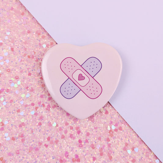 Crossed Bandages Heart Button Badge